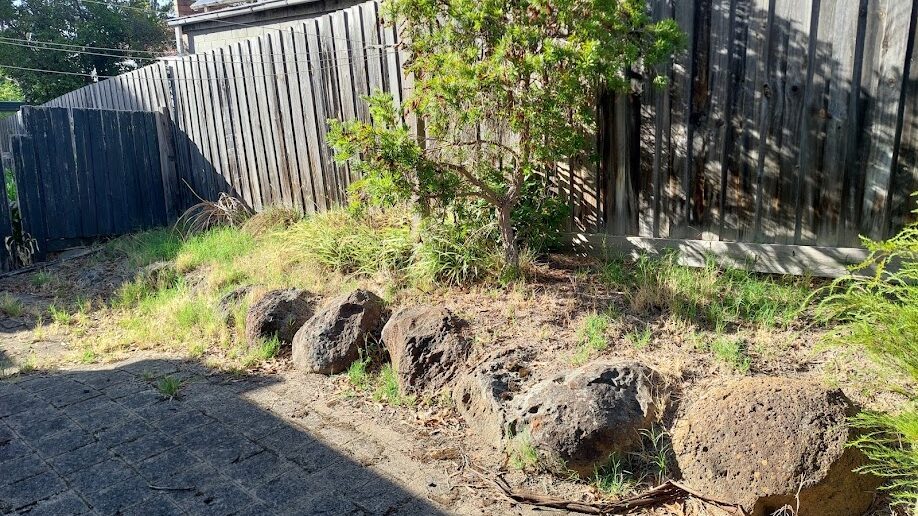 Before: Rock bed mulched. Weeds taken out from between the rocks and the bed topped with fresh mulch.